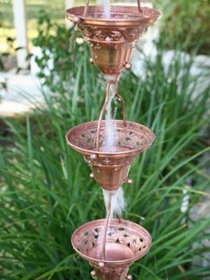 A rain chain can be used as a decorative alternative to a downspout to move rainwater away from your gutters in OKC.