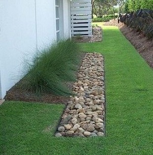 A Blind French Drain will help to prevent water from entering a basement while being not visible from the ground level.