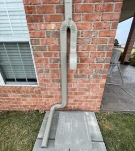 Aluminum rectangular downspouts channel rainwater away from a home's foundation to prevent pooling and structural damage.
